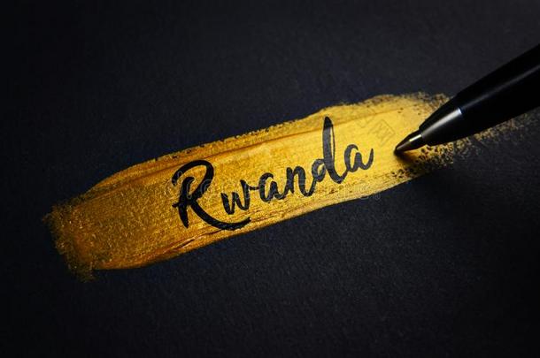卢旺达书法文本向金色的颜料刷子一击