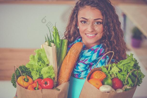 年幼的女人佃户租种的土地食品杂货店购物袋和蔬菜替身