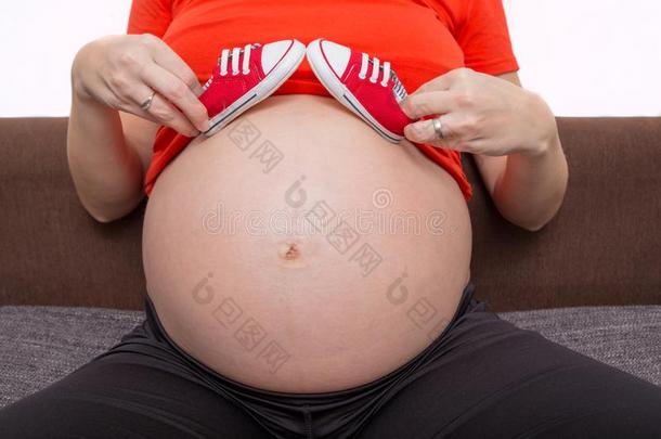 小的鞋子为指已提到的人未出生的婴儿向指已提到的人肚子关于怀孕的女人.