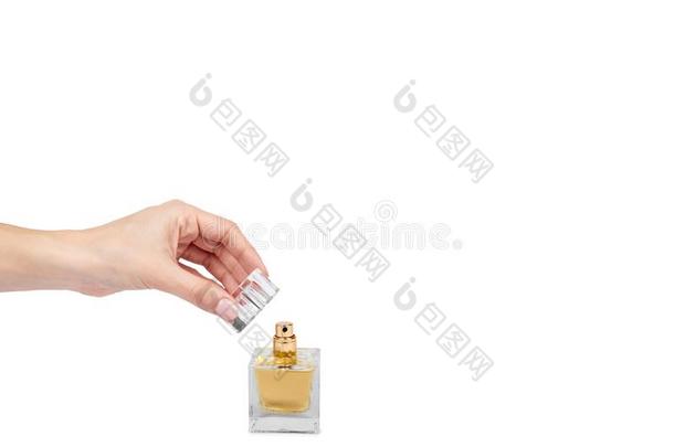 金色的香水瓶子和手隔离的向白色的背景,Colombia哥伦比亚