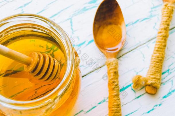 新鲜的蜂蜜采用罐子和勺为蜂蜜向老的和有裂缝的pa采用t