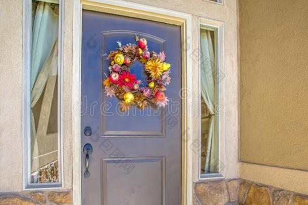 蓝色前面门和花花环在之间窗