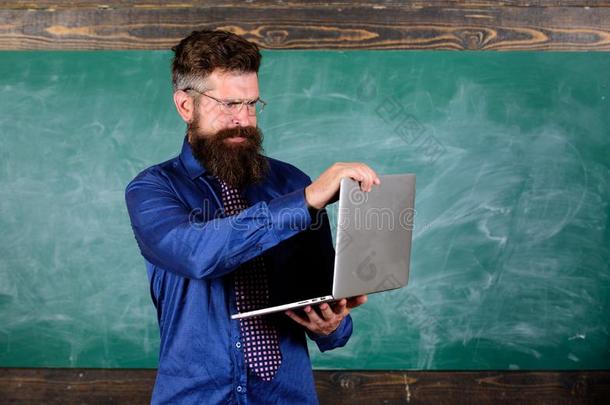 低到臀部的教师穿着眼镜和领带保存便携式电脑.现代的