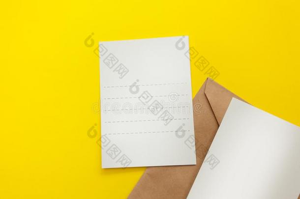 两个空白的明信片和棕色的信封向黄色的背景