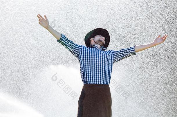 男人湿的在下面雨农场主帽子享有祈祷幸福的打翻重的湿的
