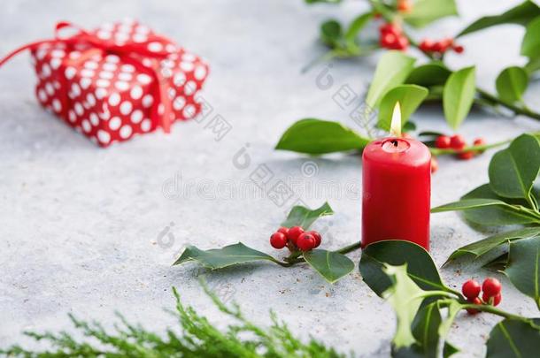 圣诞节装饰,蜡烛和冬青树叶和红色的浆果.
