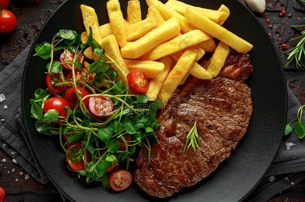 烤的牛里脊肉牛排和马铃薯炸薯条和蔬菜,番茄英文字母表的第19个字母