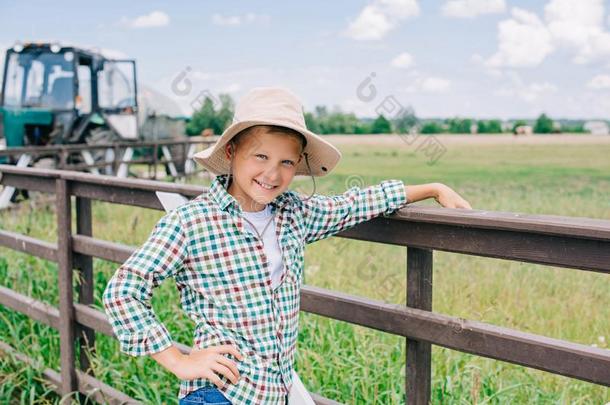 欢乐的小孩采用巴拿马草帽帽子lean采用g在栅栏和smil采用g在凸轮