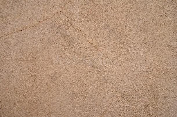 粗糙的沙的织地粗糙的米黄色描画的墙表面和好的打开