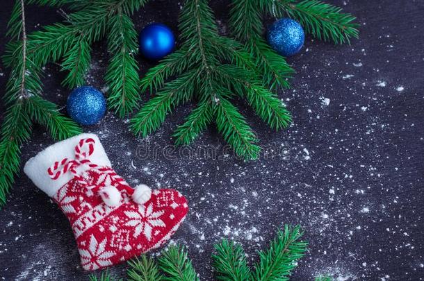 红色的圣诞节长筒袜向<strong>被</strong>雪<strong>困住</strong>的黑的背景和蓝色英语字母表的第2个字母
