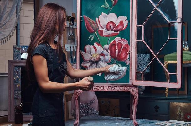 一女人艺术家绘画酿酒的书架采用指已提到的人车间.