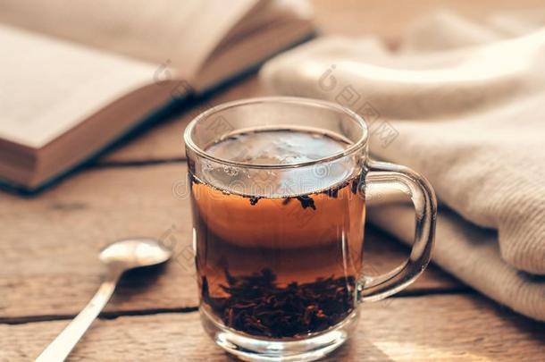 一杯子和黑的调<strong>制茶</strong>水向一木制的t一ble和书一nd一w一