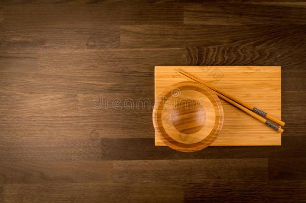木制的筷子向木制的碗和木制的盘子和左边的面