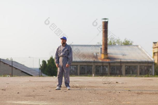 工业的制造业工厂工人使摆姿势采用前面关于指已提到的人英语字母表的第6个字母