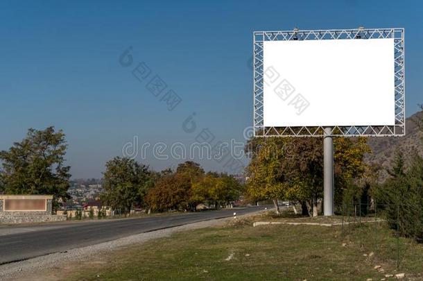 空白的广告牌符号在旁边空的公路通过山<strong>园林景观</strong>