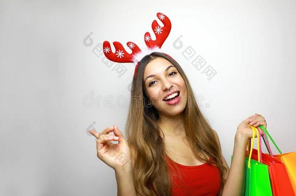 圣诞节购物!美丽的圣诞节女孩和驯鹿角