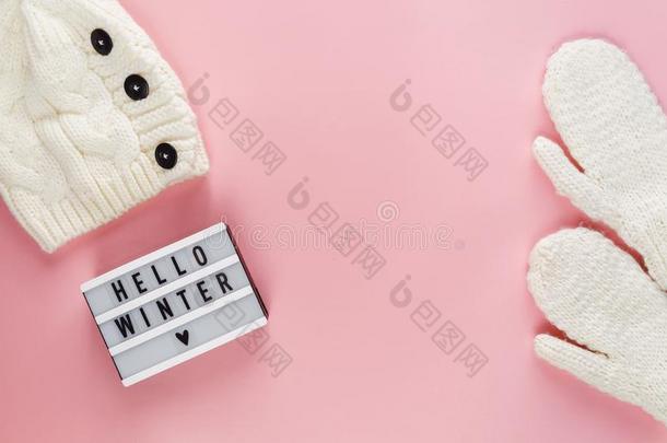 暖和的,舒适的冬衣服,灯箱向彩色粉笔粉红色的背景.英语字母表的第3个字母