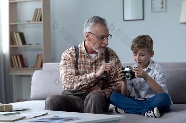 爷爷讲解孙子怎样向使用制动火箭照相机,年幼的pho向