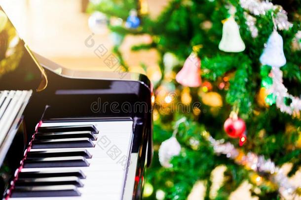 <strong>钢琴</strong>和发出光向圣诞节树为圣诞节假日后台