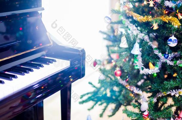 钢琴和<strong>发出</strong>光向圣诞节树为圣诞节假日后台