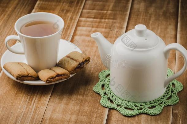 白色的<strong>茶壶</strong>和杯子关于茶水和甜饼干/白色的<strong>茶壶</strong>和杯子关于