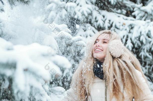 美丽的微笑的女人有一乐趣户外的向下雪的we一ther.