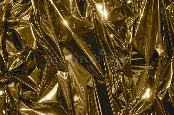 金色的<strong>金属箔</strong>,有皱纹的和发光的.关-在上面,抽象的影像