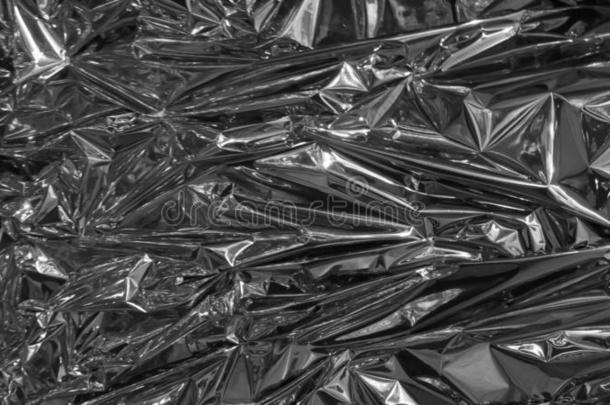 银<strong>金属箔</strong>,有皱纹的和发光的.关-在上面,抽象的影像