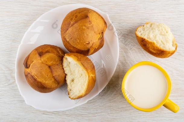 小麦圆形的小面包或点心采用盘子,杯子关于奶,破碎的圆形的小面包或点心向表.顶看法