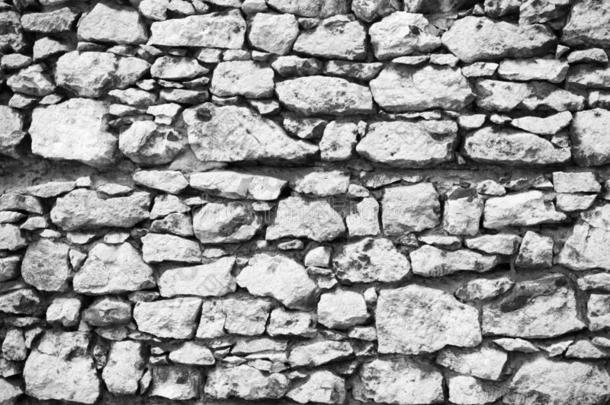 老的多石头的墙采用克拉科夫质地背景.古代的背景