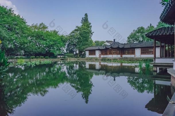 传统的中国人房屋在旁边池塘和反映采用水,采用一