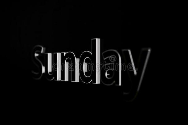 星期日标题.单词星期日生气越过黑的和灰色的后台