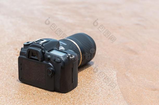 单眼数位相机照相机向海滩湿的从水海波浪