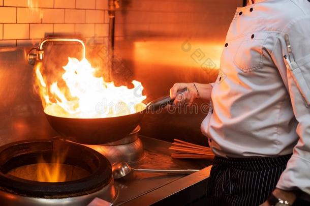 一男人烹调烹饪术深的油炸锅采用一厨房火
