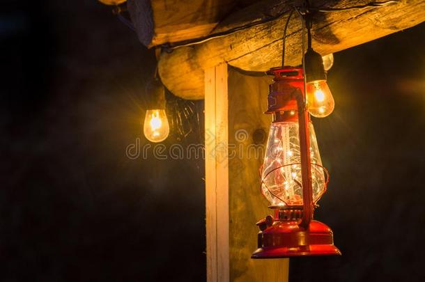 红色的金属暴<strong>风雨</strong>灯笼悬在外面乡村的记录小木屋.