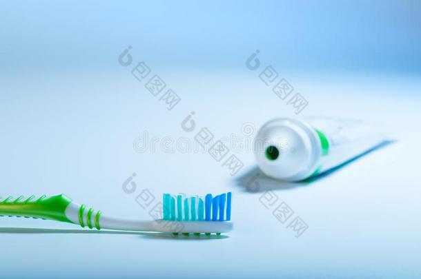 牙刷和牙膏管向蓝色背景