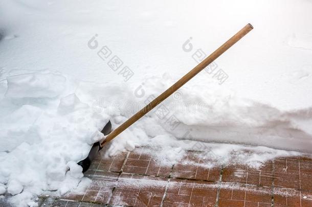 大的黑的塑料制品铲子和木制的手感驾驶采用雪堆.