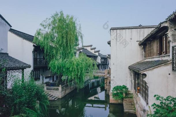 传统的中国人黑的和白色的住宅在旁边河,采用在商业区
