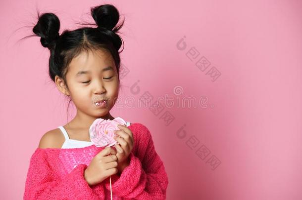 幸福的年幼的亚洲人小的女孩小孩舔吃幸福的大的甜的棒糖