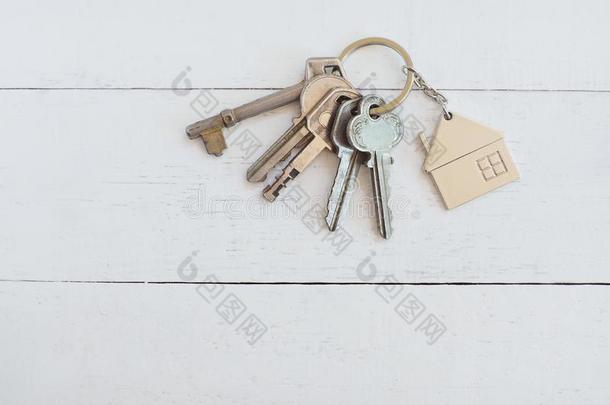 家钥匙和房屋钥匙ring向白色的木材表背景,支柱