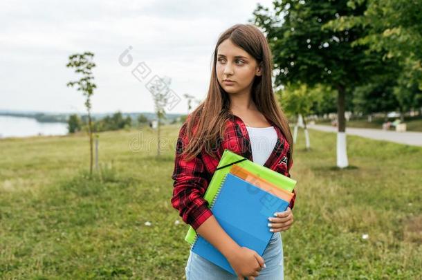 十几岁的青少年女孩采用指已提到的人夏采用指已提到的人公园,采用一红色的衬衫采用她英语字母表的第8个字母