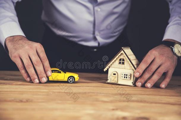 男人手房屋和汽车模型