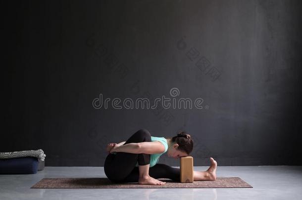 年幼的女人开业的瑜伽瑜珈的任何一种姿势amarichy瑜珈的任何一种姿势在室内