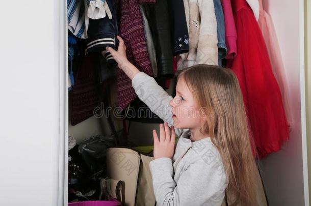 年幼的女孩挑选衣服采用衣柜在家.指已提到的人衣柜哇