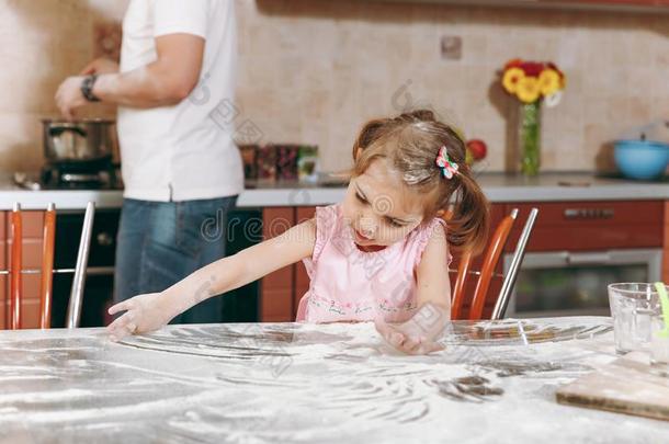 小的小孩女孩比赛和面粉在期间爸爸烹饪术采用厨房一