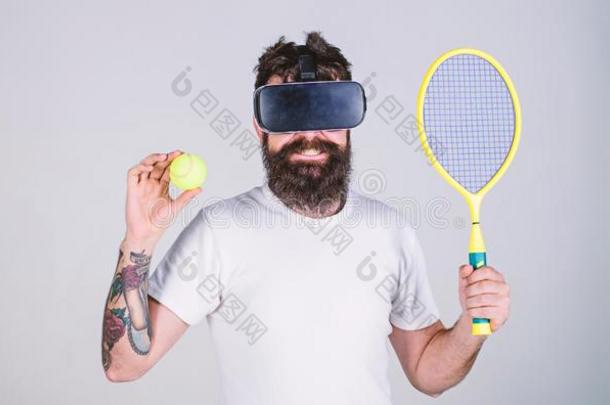 家伙和VirtualReality虚拟现实眼镜比赛网球和球拍和球.男人和英语字母表的第2个字母