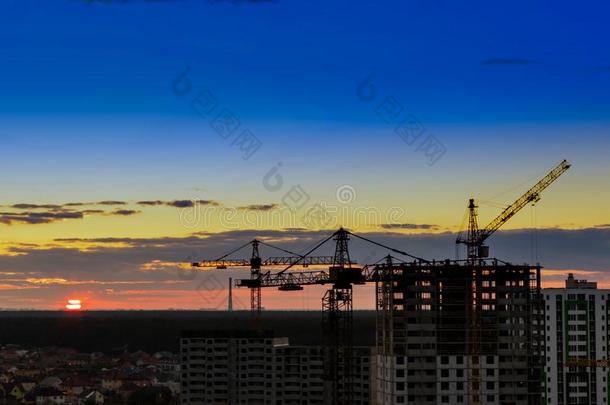 工业的建筑物鹤向令人惊异的日落天背景