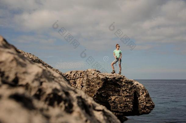 年幼的女孩起立向指已提到的人岩石在近处指已提到的人海