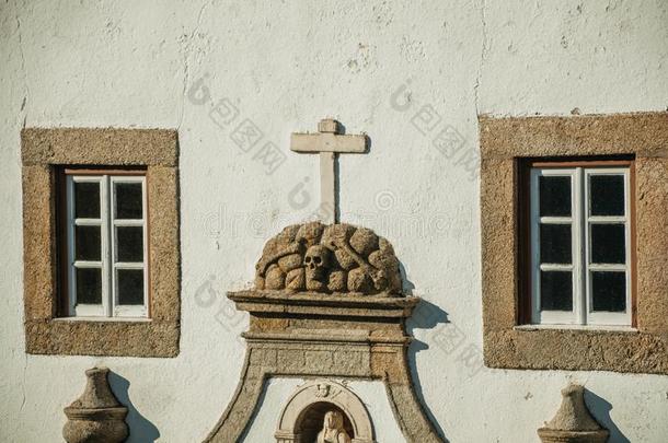 颅骨和十字架有雕刻的采用石头向指已提到的人建筑物的正面关于教堂
