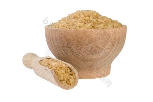 棕色的稻采用木制的碗和铲隔离的向白色的背景